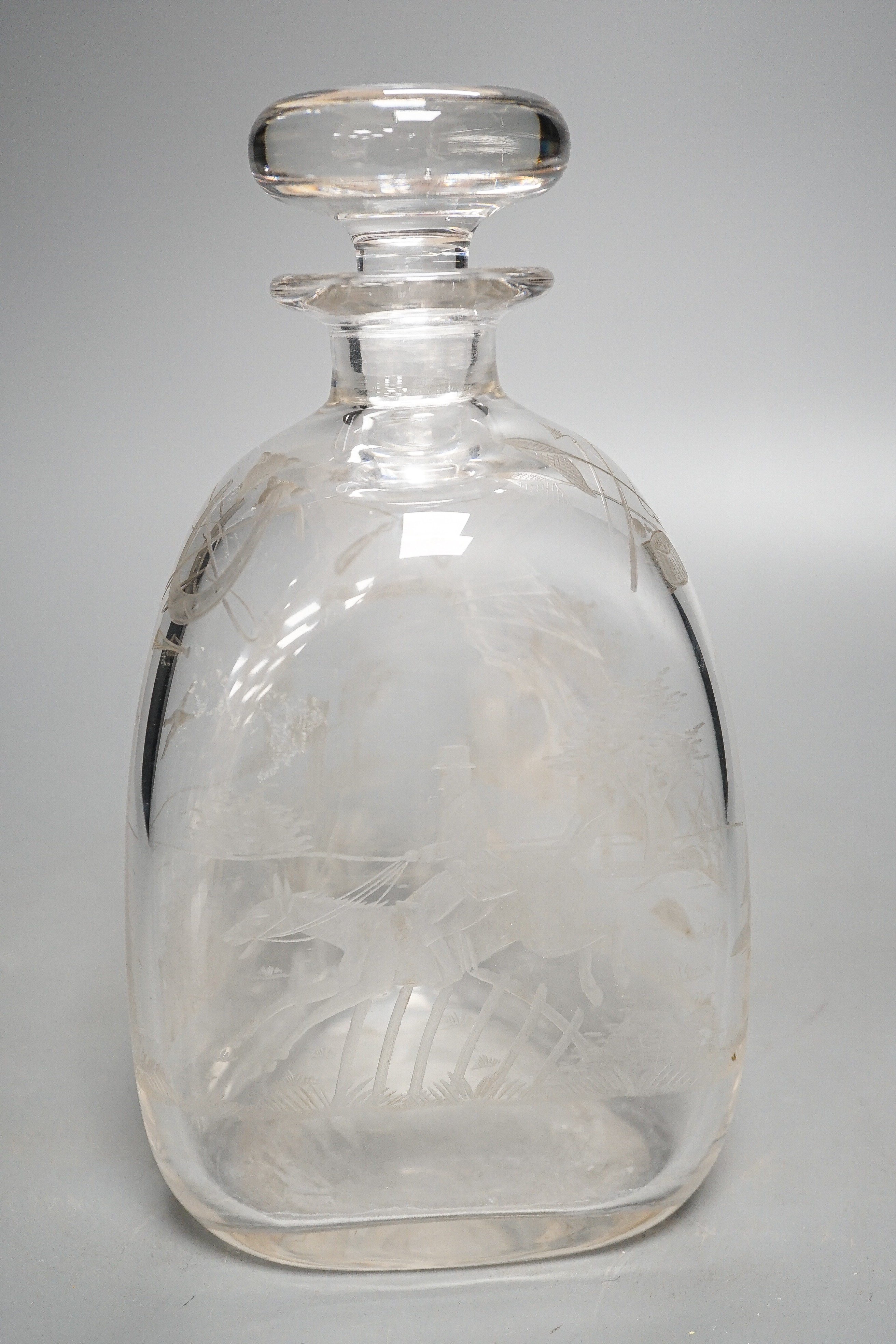 Hunting interest - A Victorian wheel engraved triangular glass decanter, and stopper, 22 cms high.